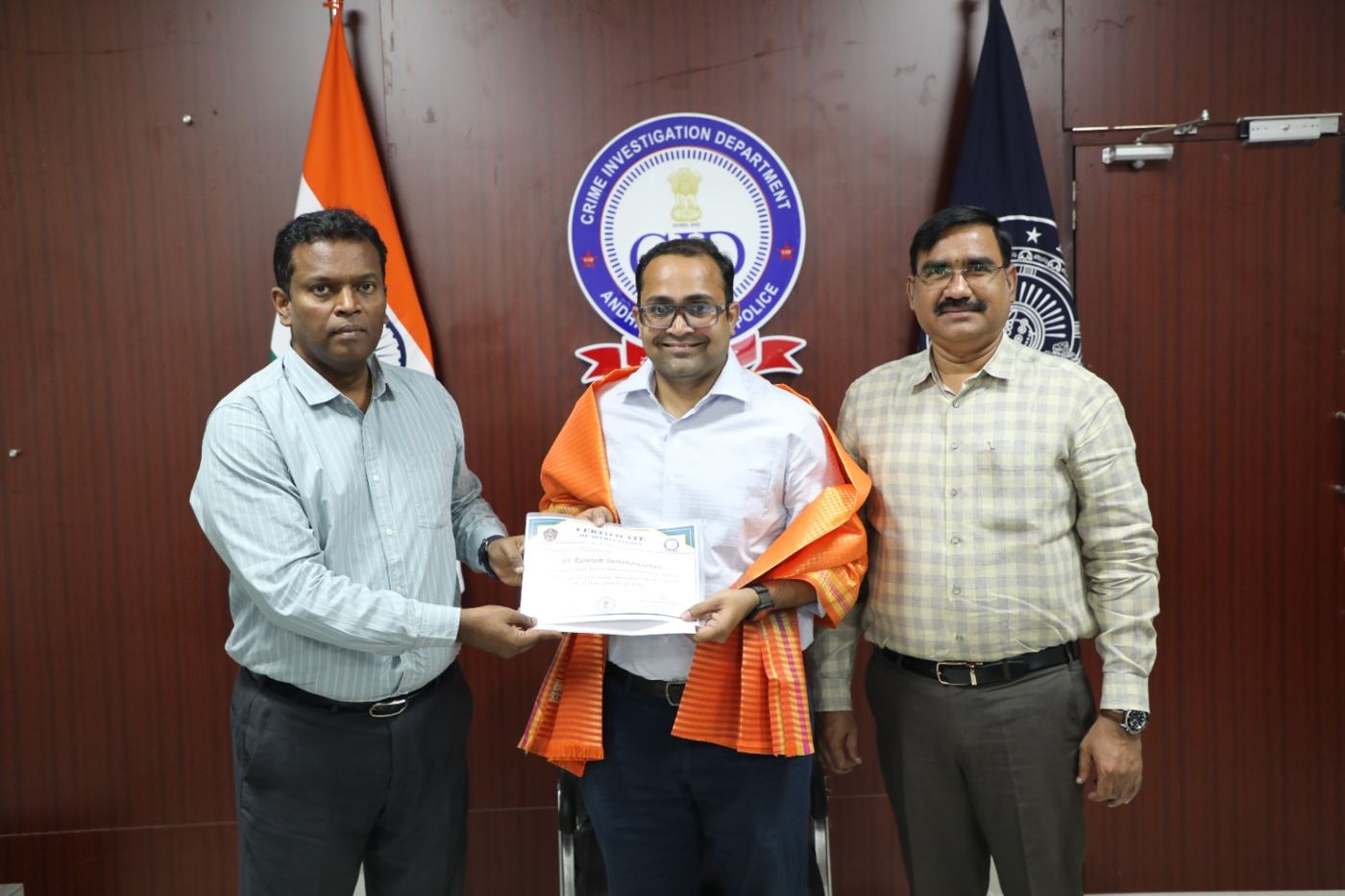 Receiving a Certificate of Appreciation from AP CID officers
