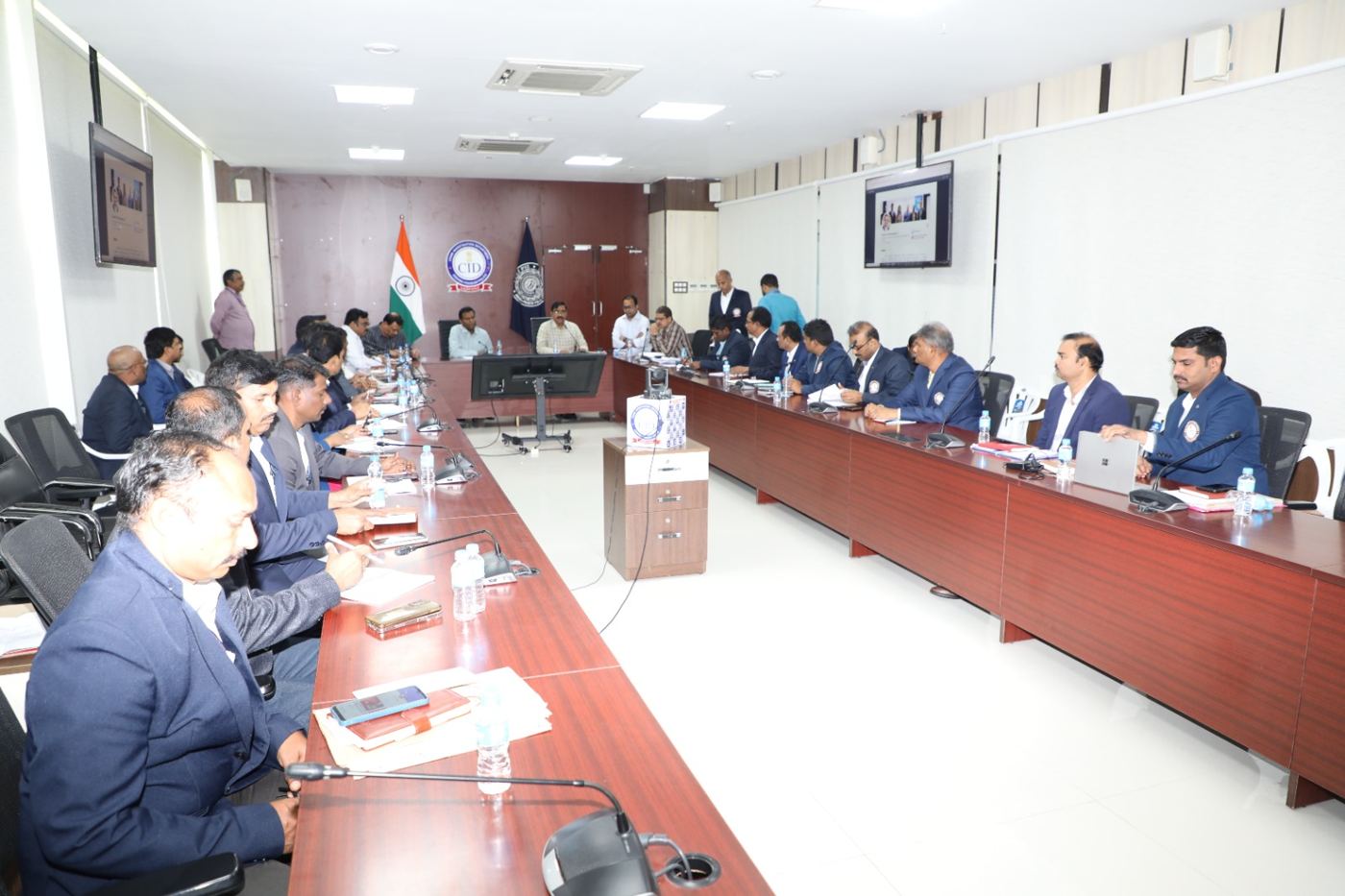Officers seated around the conference table during the session